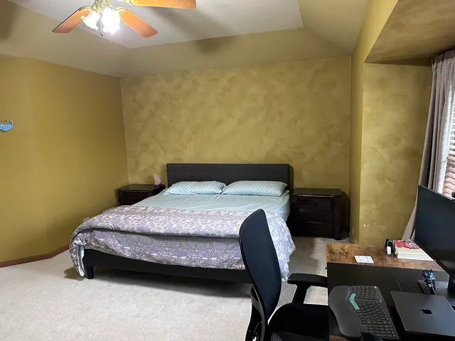 a bedroom with bed and a window