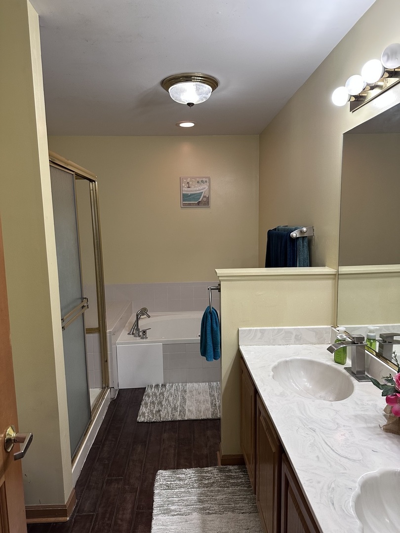 2153 Seaver Lane Hoffman Estates, IL 60169 - Photo 24 of 36 a bathroom with a granite countertop sink a toilet and a mirror