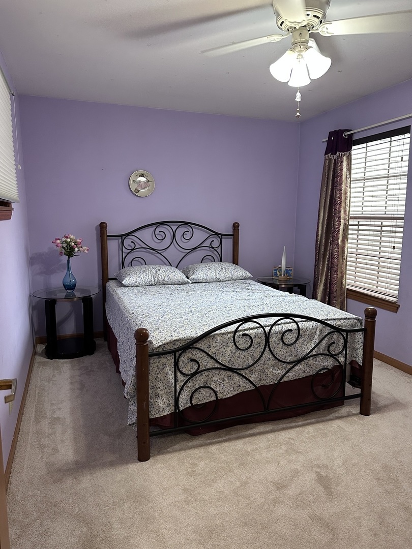 2153 Seaver Lane Hoffman Estates, IL 60169 - Photo 25 of 36 a bedroom with a bed and a chandelier