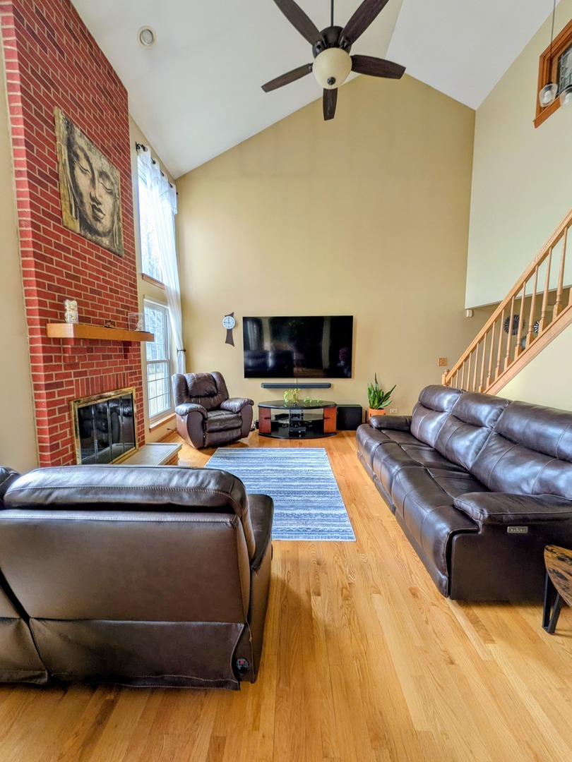 2153 Seaver Lane Hoffman Estates, IL 60169 - Photo 8 of 36 a living room with a flat screen tv and a fireplace