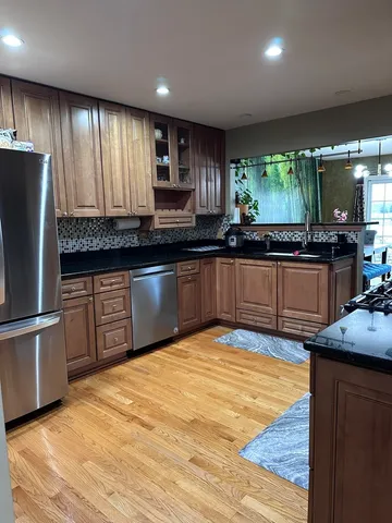 a kitchen with granite countertop a stove and cabinets
