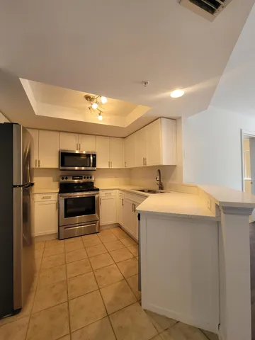 a kitchen with a sink appliances and cabinets
