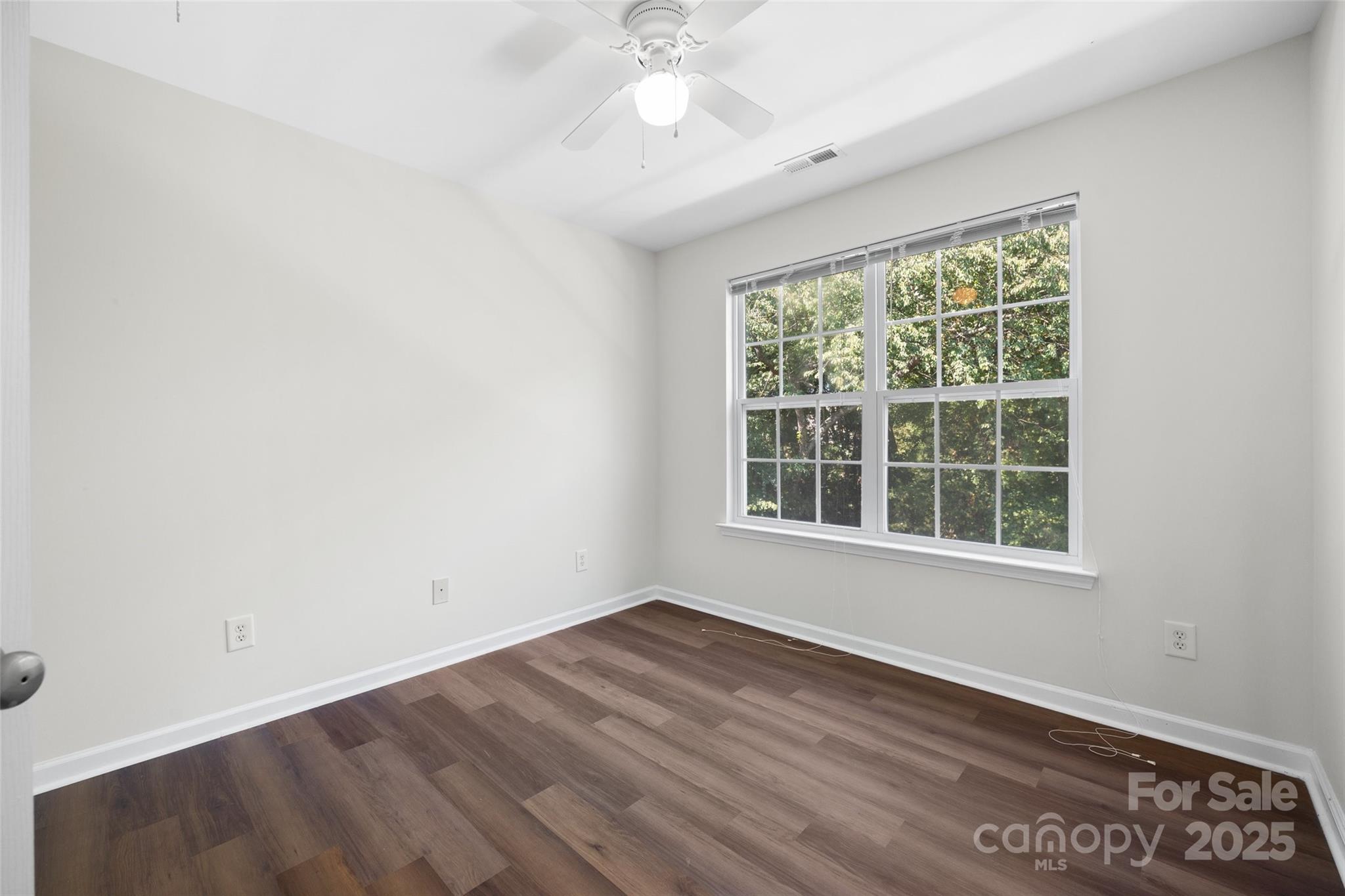 975 Copperstone Lane Fort Mill, SC 29708 - Photo 19 of 35 an empty room with wooden floor and windows