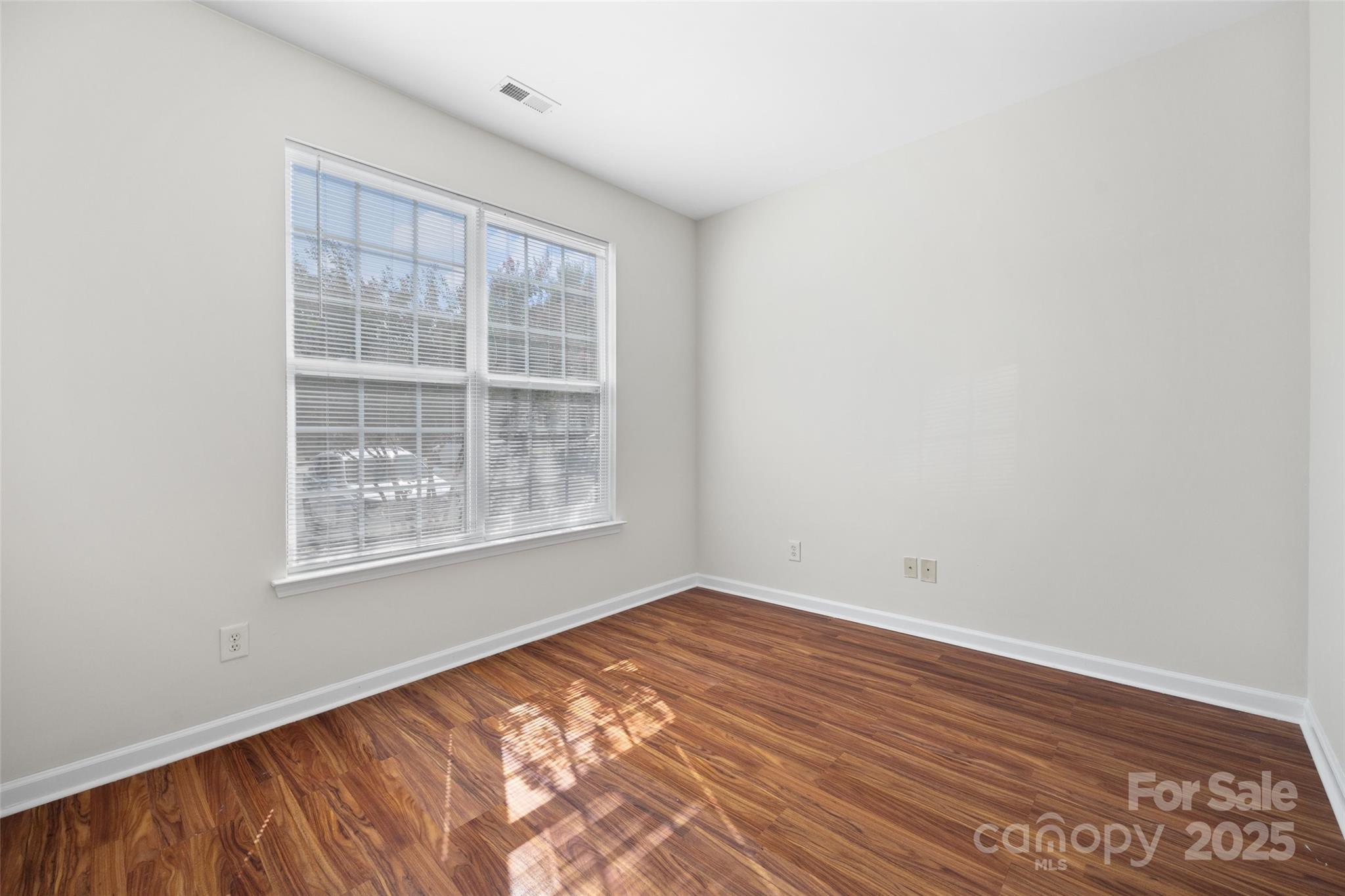 975 Copperstone Lane Fort Mill, SC 29708 - Photo 5 of 35 a view of an empty room with wooden floor and a window