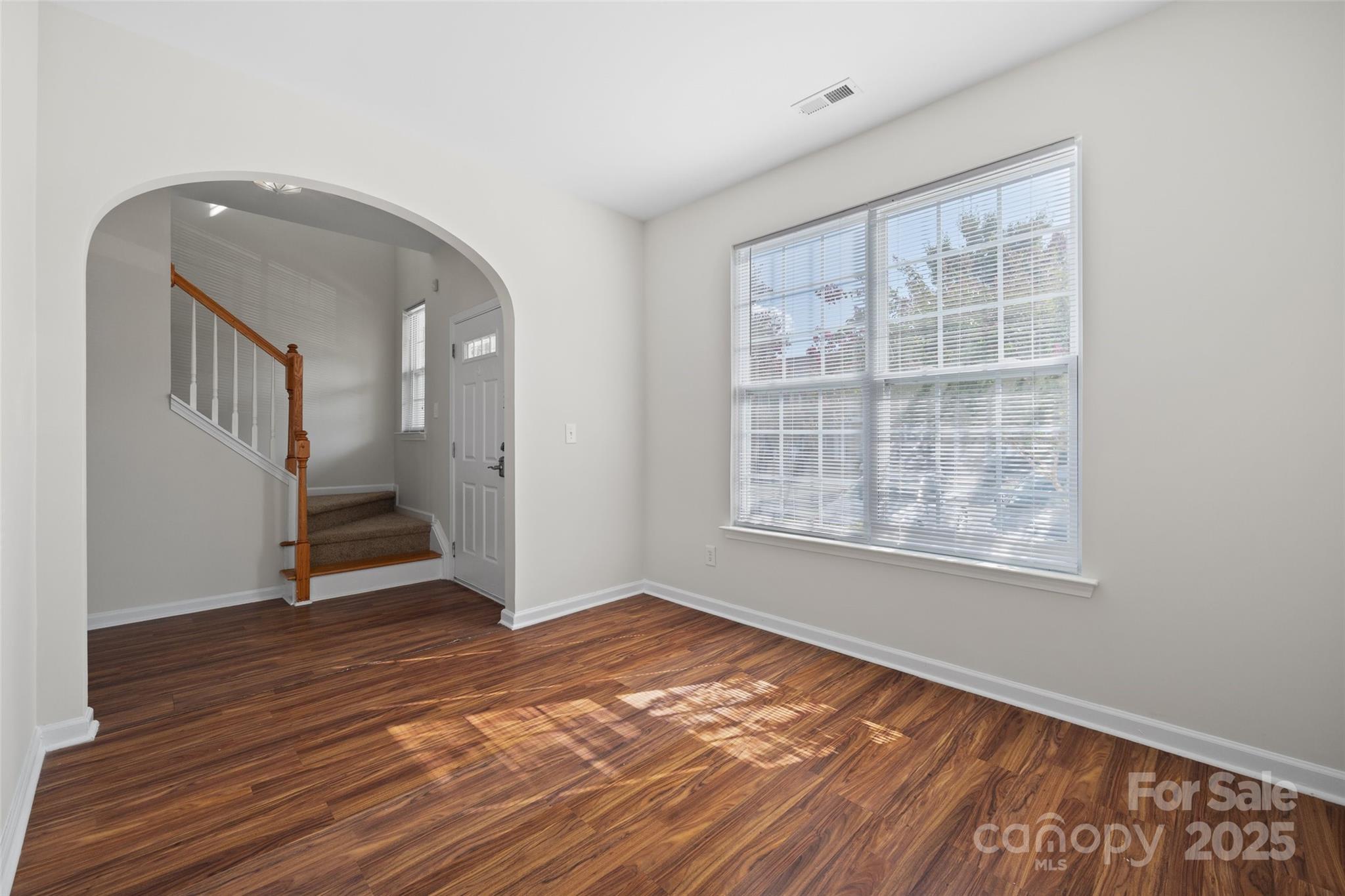 975 Copperstone Lane Fort Mill, SC 29708 - Photo 6 of 35 a view of an empty room with wooden floor and a window