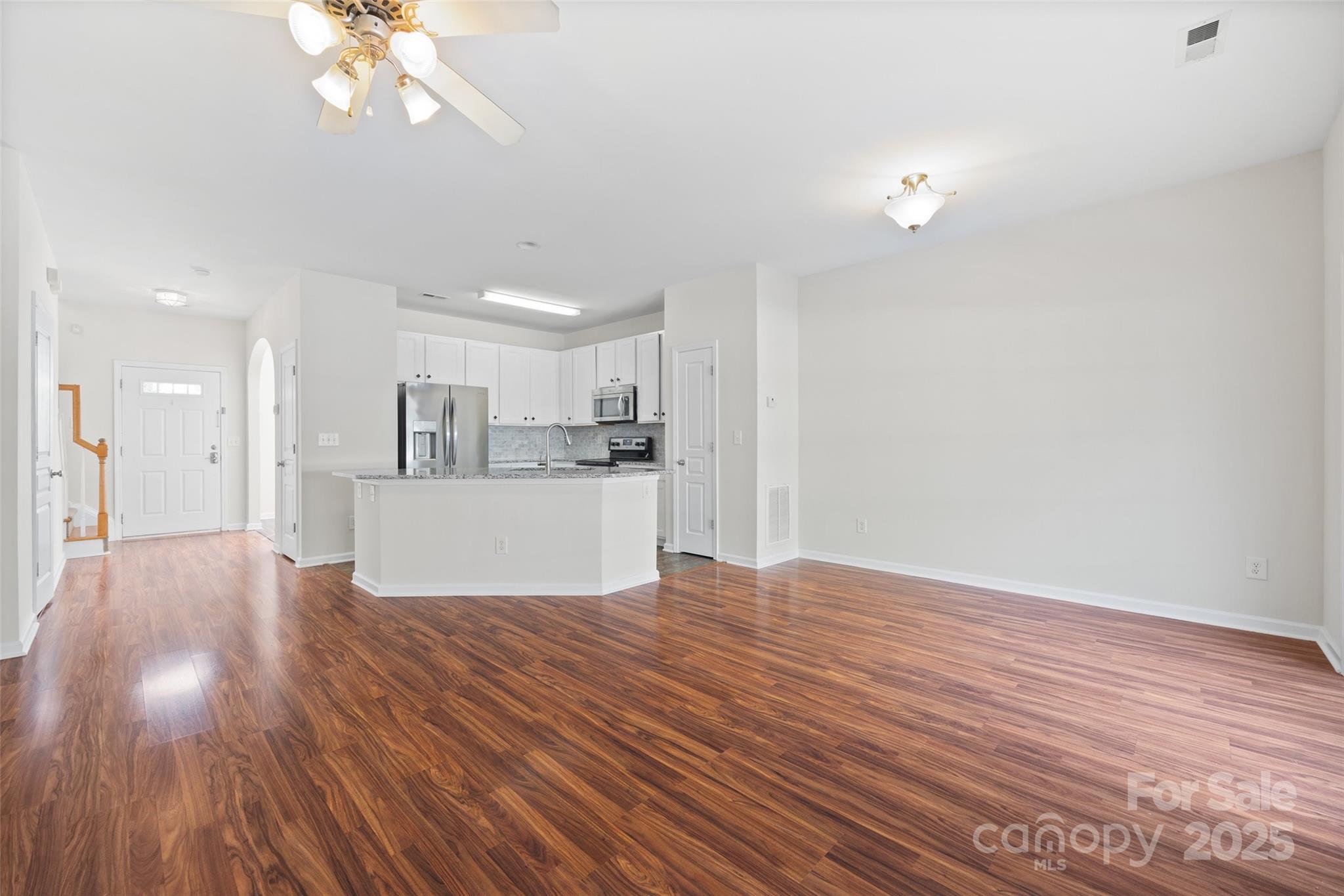 975 Copperstone Lane Fort Mill, SC 29708 - Photo 8 of 35 a view of kitchen and empty room with wooden floor