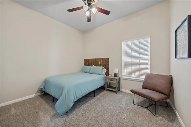 a bedroom with a bed and a couch