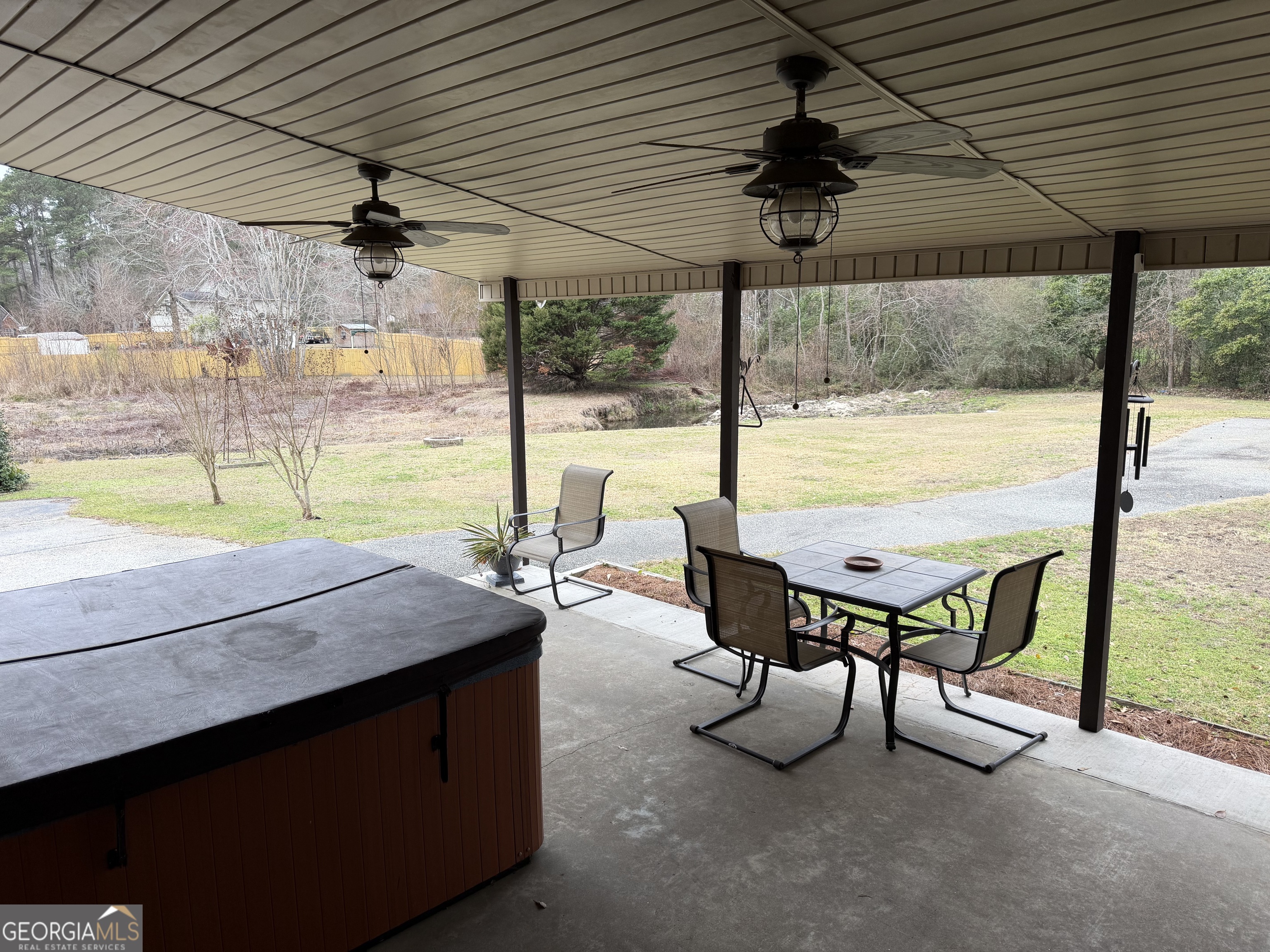 223 Trinity Road Dublin, GA 31021 - Photo 15 of 42 a view of a patio with a table and chairs under an umbrella