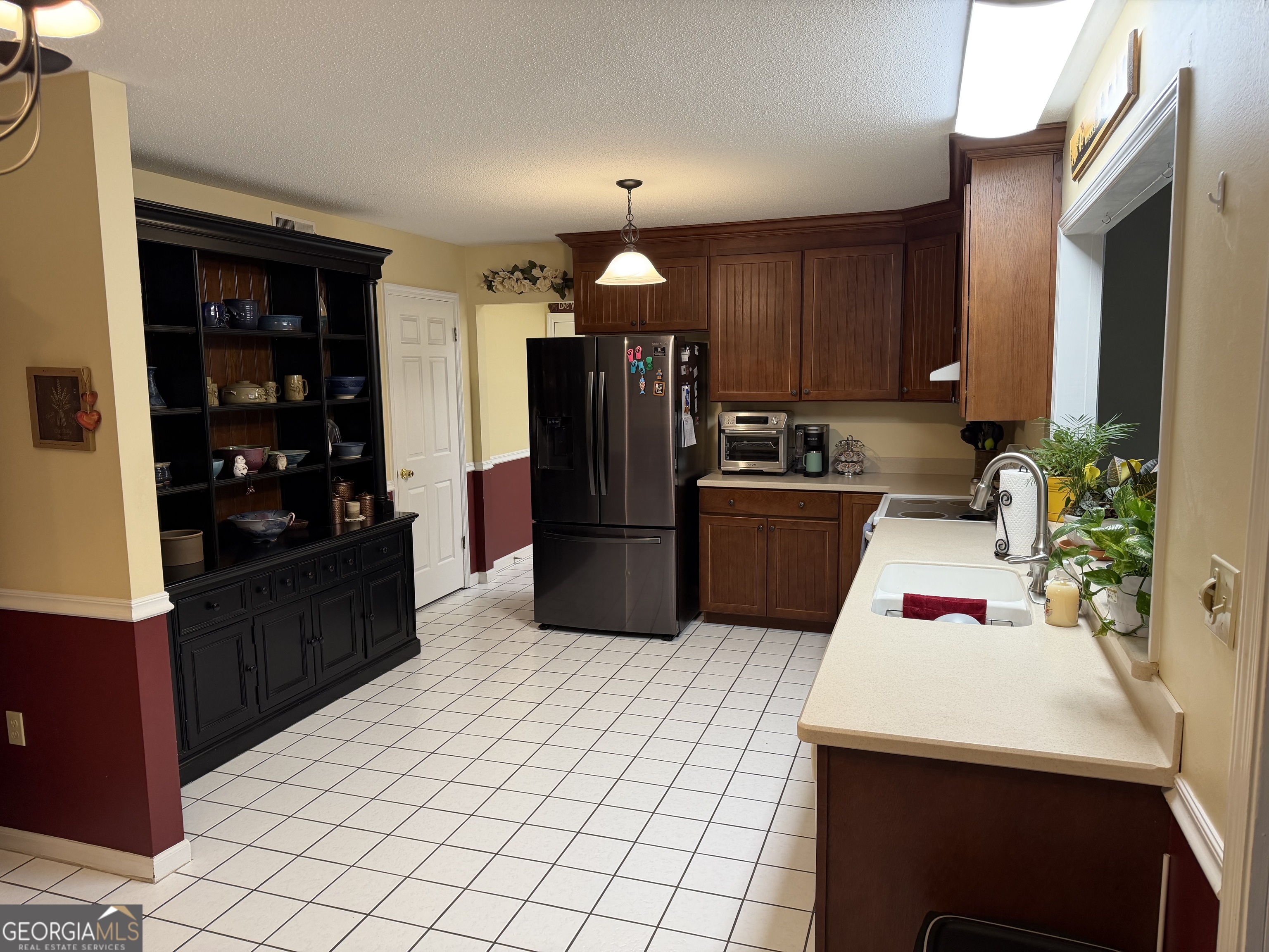 223 Trinity Road Dublin, GA 31021 - Photo 17 of 42 a kitchen with a sink appliances and cabinets