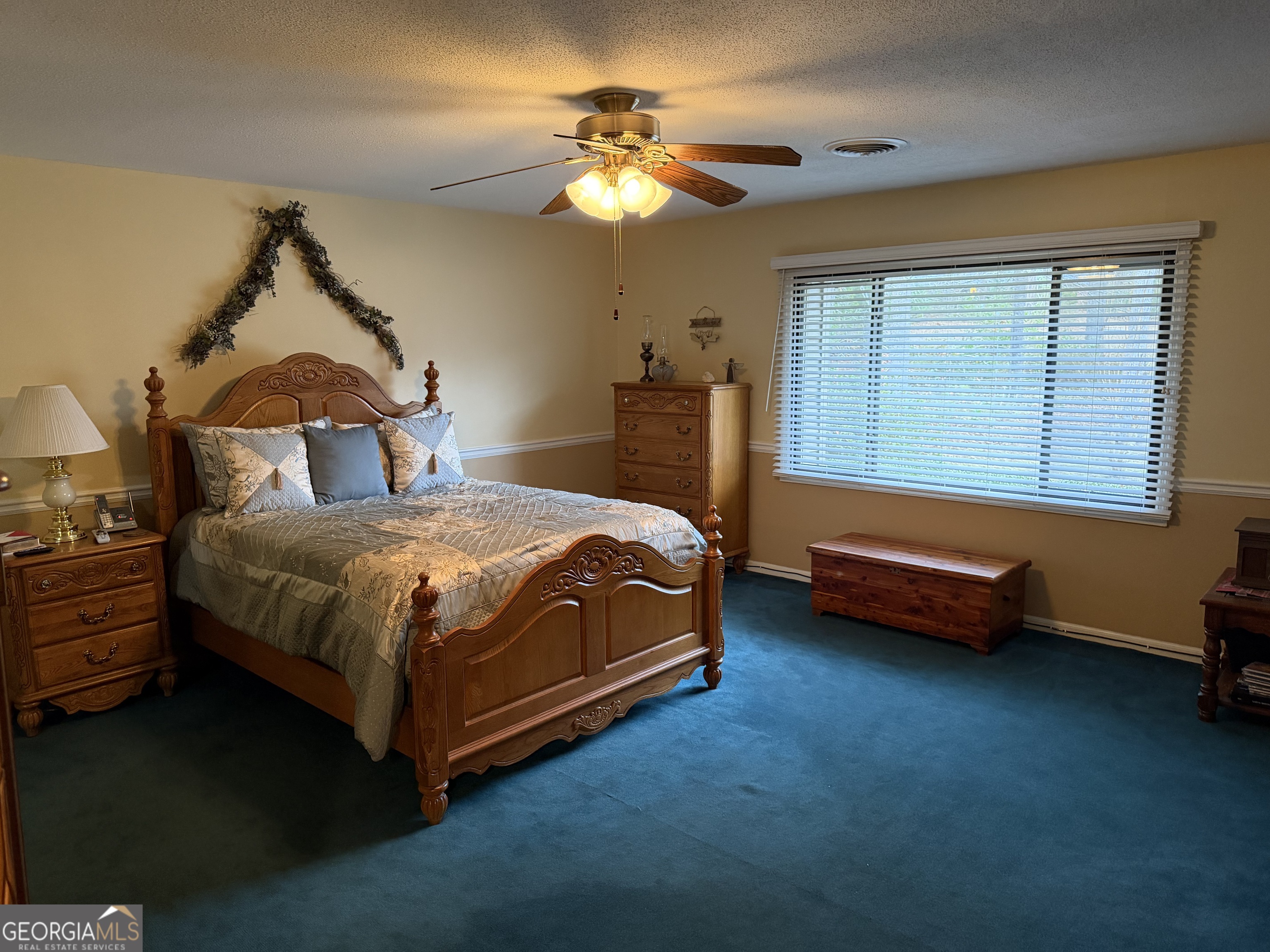223 Trinity Road Dublin, GA 31021 - Photo 24 of 42 a bedroom with a bed and a chandelier