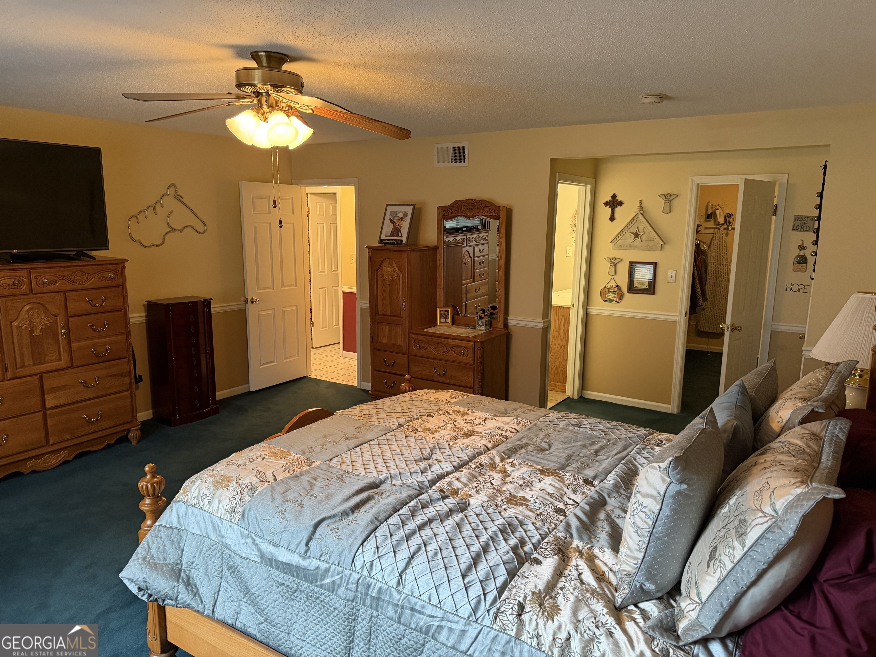 223 Trinity Road Dublin, GA 31021 - Photo 26 of 42 a bedroom with a bed and a flat tv screen on dresser