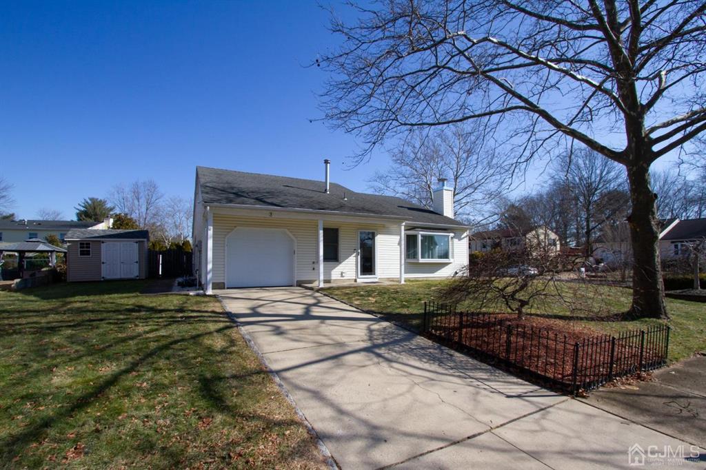 a view of a house with backyard and sitting area