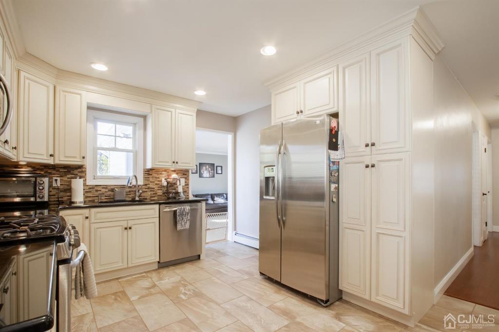 3 Stone Court Old Bridge, NJ 07747 - Photo 11 of 25 a kitchen with stainless steel appliances granite countertop a refrigerator and a stove top oven