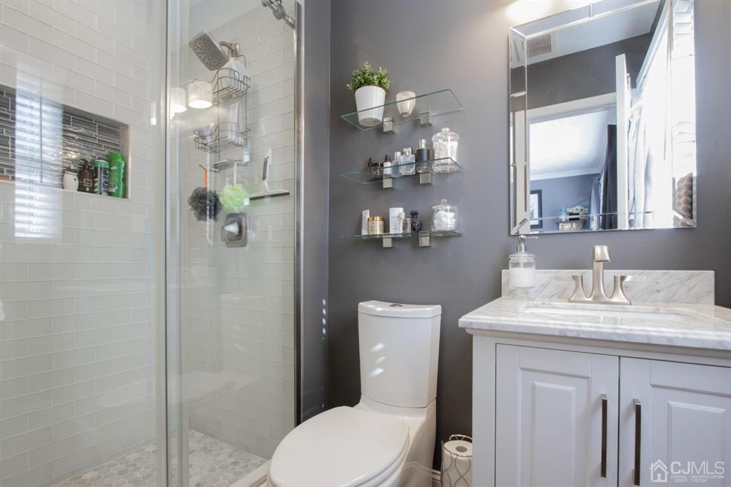 3 Stone Court Old Bridge, NJ 07747 - Photo 17 of 25 a bathroom with a granite countertop sink a toilet and a mirror