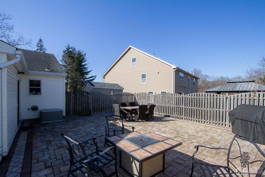 3 Stone Court Old Bridge, NJ 07747 - Photo 22 of 25 a roof deck with table and chairs and potted plants with wooden floor and fence