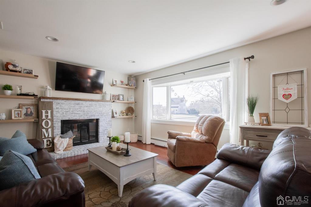 3 Stone Court Old Bridge, NJ 07747 - Photo 4 of 25 a living room with furniture a flat screen tv and a fireplace