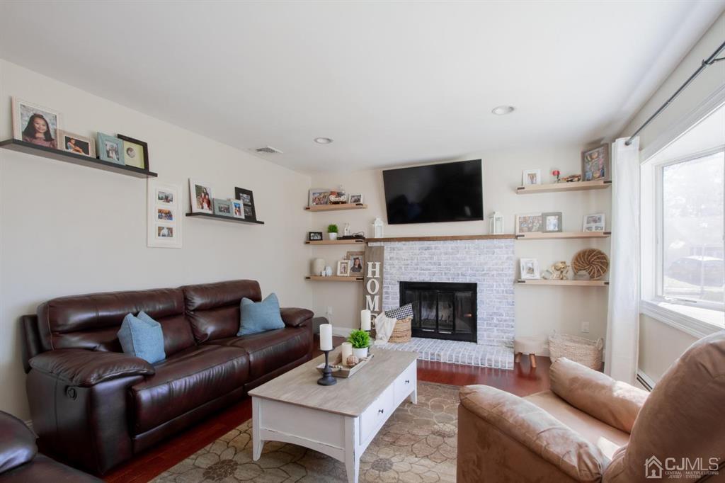 3 Stone Court Old Bridge, NJ 07747 - Photo 5 of 25 a living room with furniture a fireplace and a flat screen tv