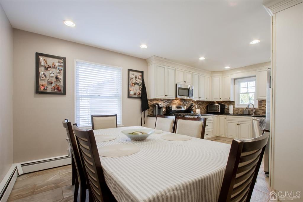 3 Stone Court Old Bridge, NJ 07747 - Photo 8 of 25 a large white kitchen with a dining table and chairs