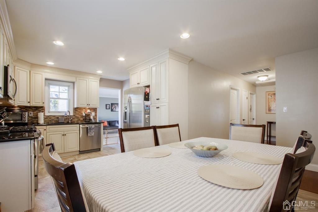 3 Stone Court Old Bridge, NJ 07747 - Photo 9 of 25 a kitchen with a table chairs stove and wooden floor