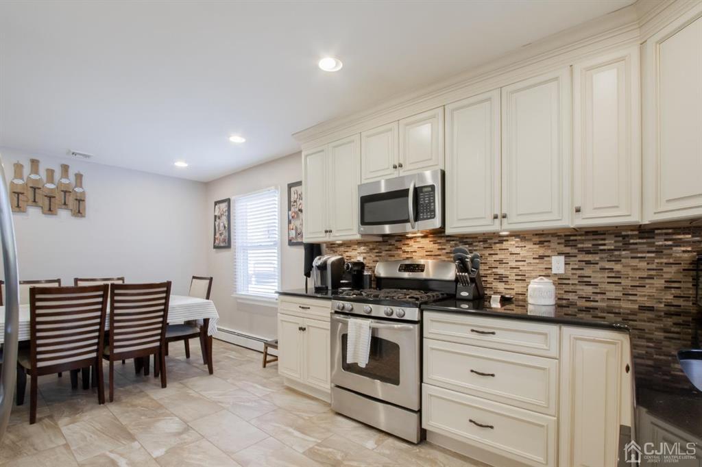 3 Stone Court Old Bridge, NJ 07747 - Photo 10 of 25 a kitchen with white cabinets and appliances