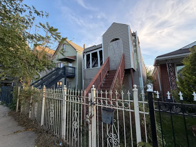a front view of a house with iron fence