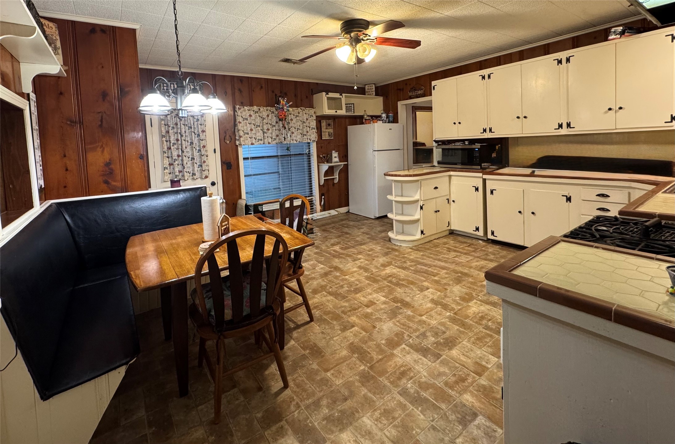 3706 College Street Damon, TX 77430 - Photo 11 of 22 a kitchen with stainless steel appliances kitchen island granite countertop a table chairs in it and wooden floors