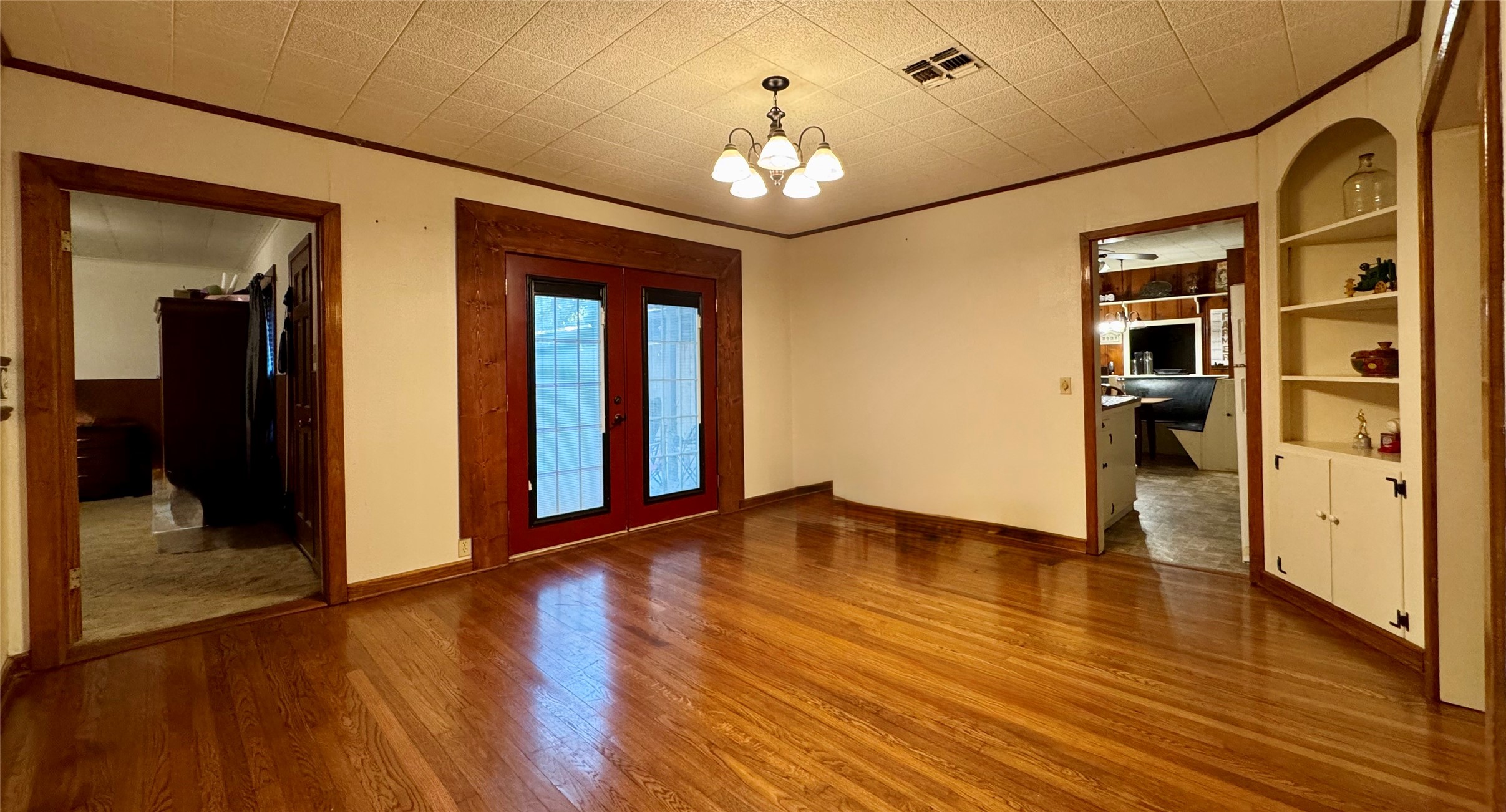 3706 College Street Damon, TX 77430 - Photo 15 of 22 a view of a hallway with wooden floor and a chandelier