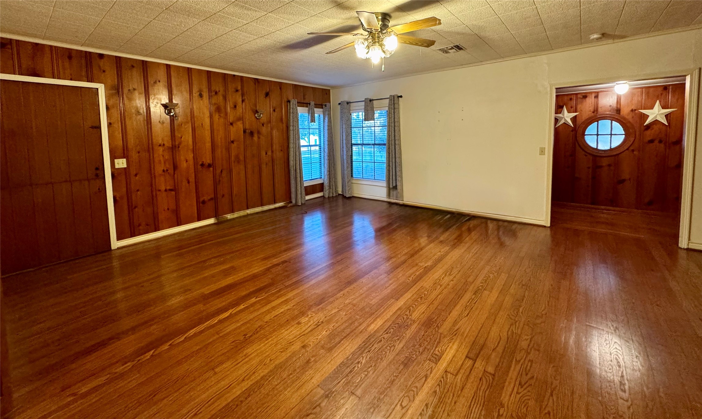 3706 College Street Damon, TX 77430 - Photo 16 of 22 a view of an empty room with wooden floor and window