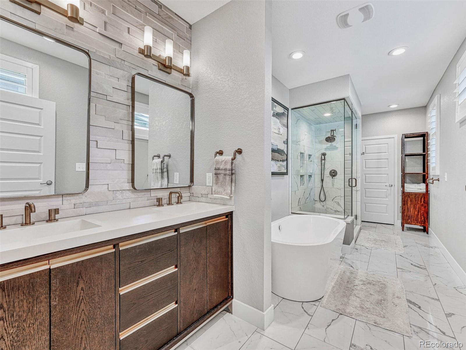 10132 Belvedere Loop Lone Tree, CO 80124 - Photo 15 of 37 a spacious bathroom with a toilet sink and mirror