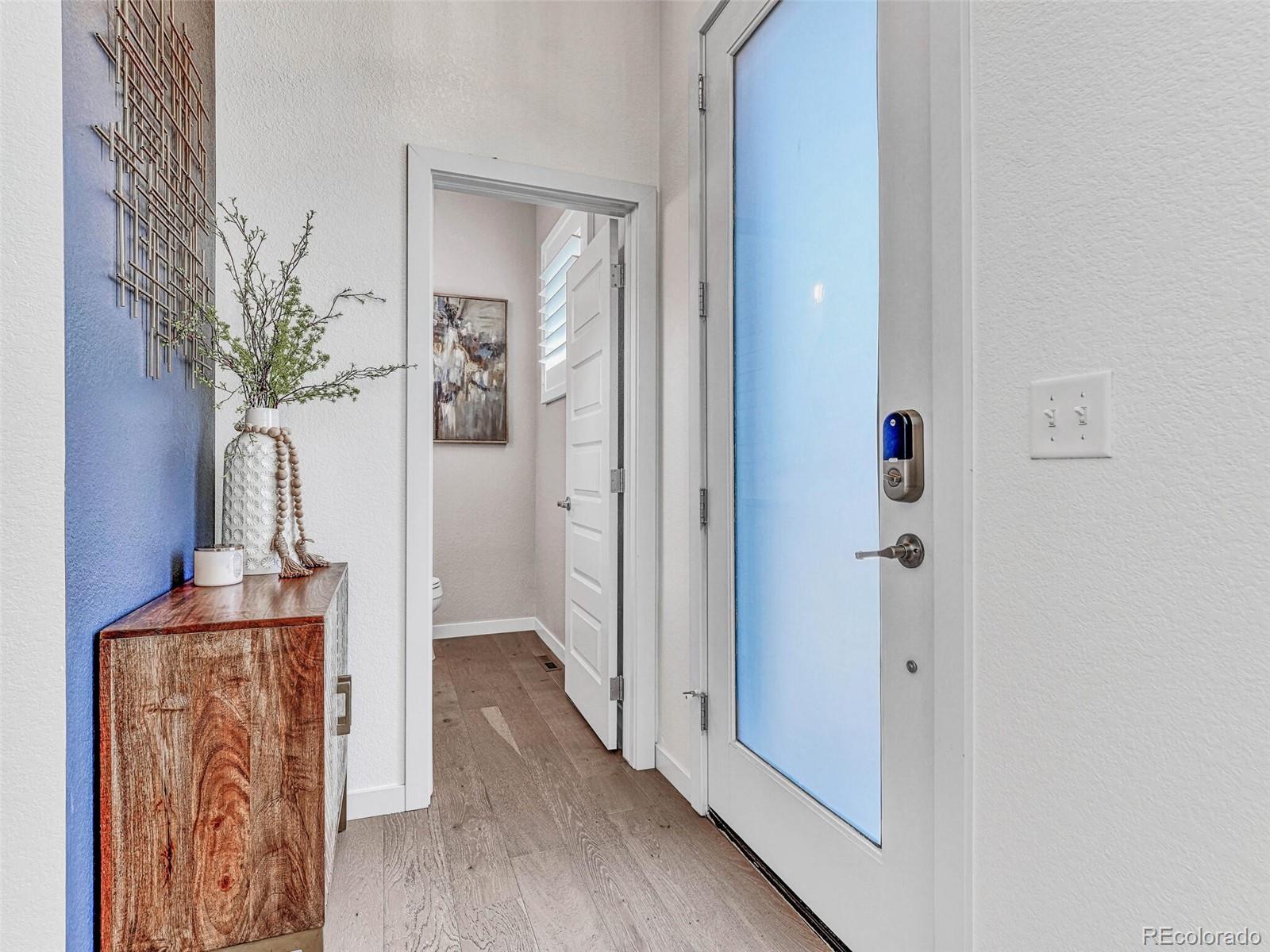 10132 Belvedere Loop Lone Tree, CO 80124 - Photo 2 of 37 a view of a hallway with wooden floor and a potted plant