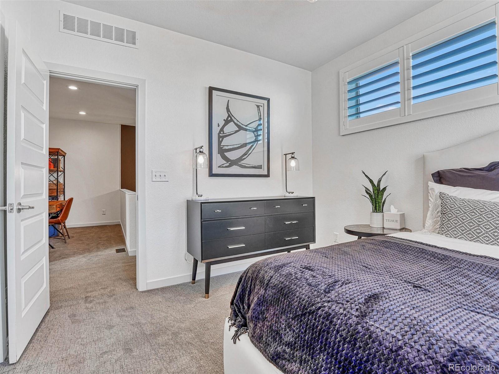 10132 Belvedere Loop Lone Tree, CO 80124 - Photo 21 of 37 a bedroom with a bed and a couch