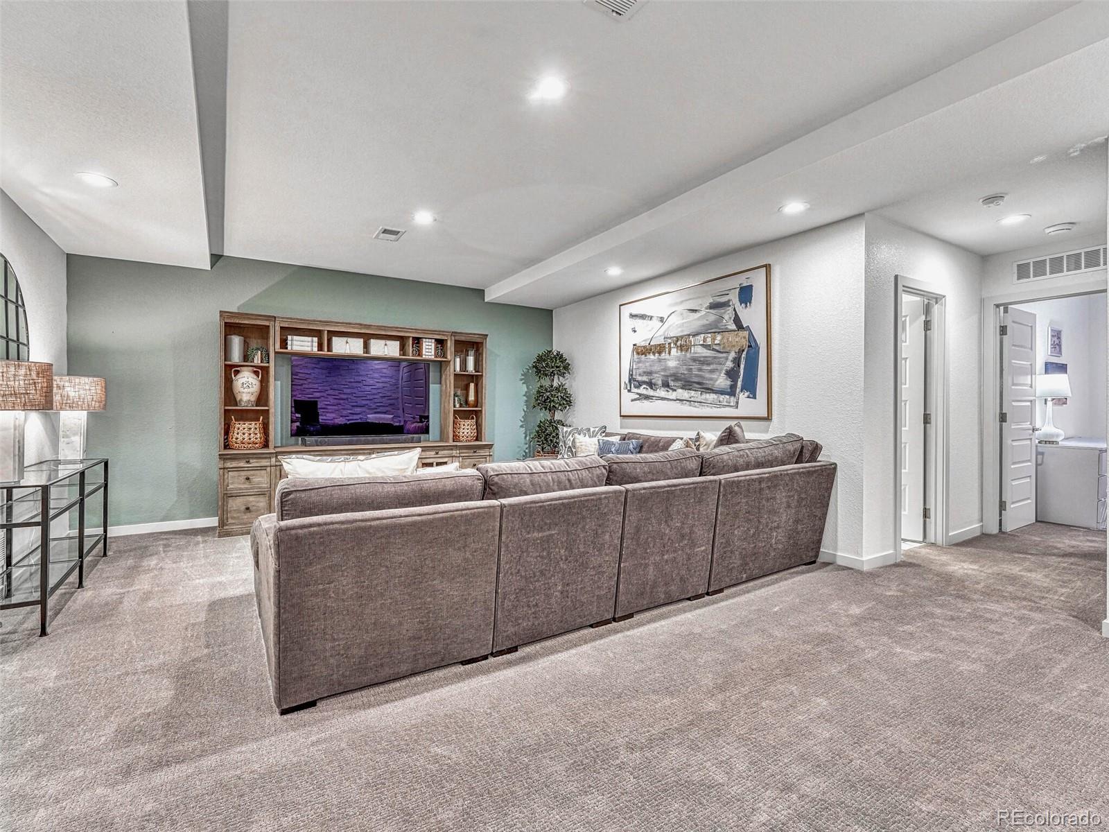 10132 Belvedere Loop Lone Tree, CO 80124 - Photo 23 of 37 a living room with furniture and a flat screen tv