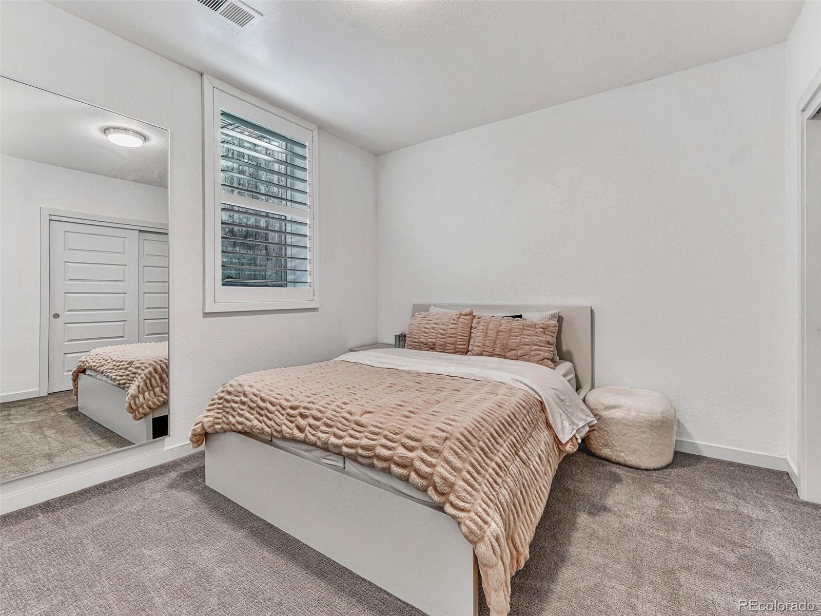 10132 Belvedere Loop Lone Tree, CO 80124 - Photo 28 of 37 a bedroom with a bed and window