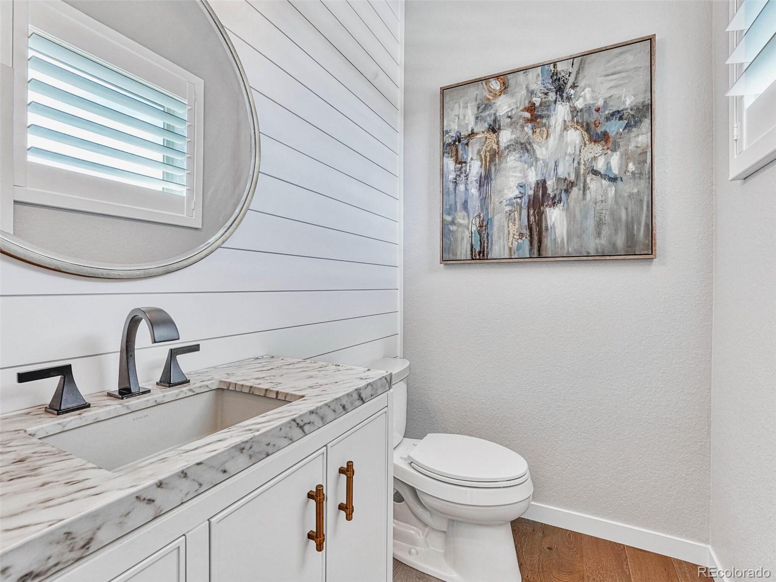 10132 Belvedere Loop Lone Tree, CO 80124 - Photo 30 of 37 a bathroom with a toilet sink and mirror