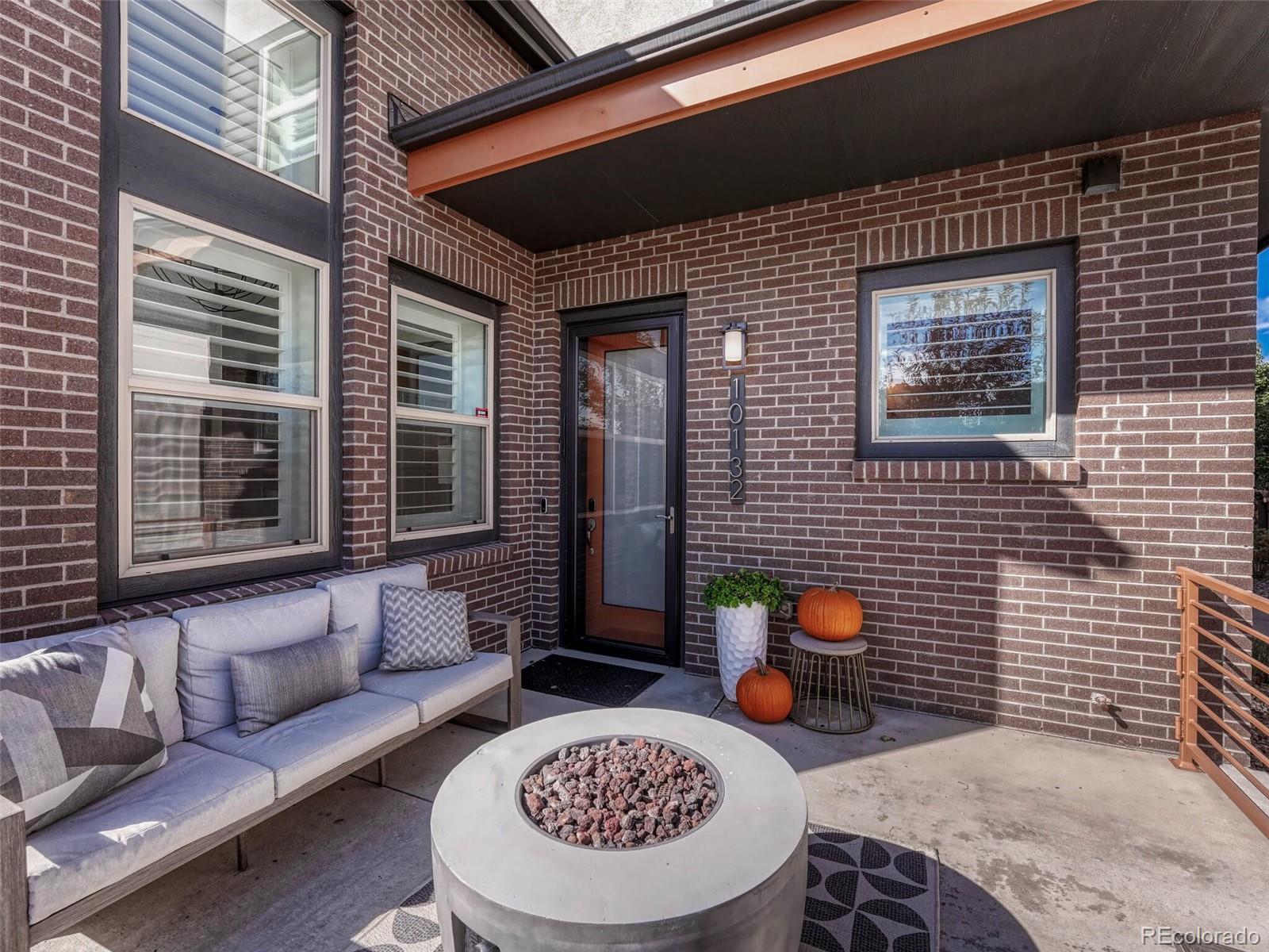 10132 Belvedere Loop Lone Tree, CO 80124 - Photo 35 of 37 a view of a patio with couches table and chairs and potted plants