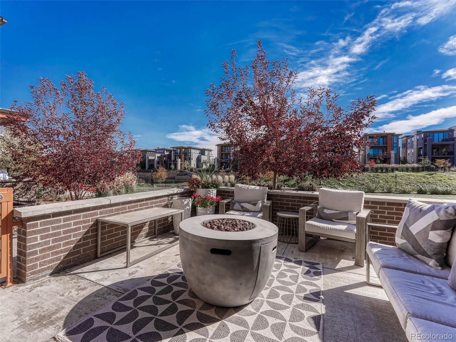 10132 Belvedere Loop Lone Tree, CO 80124 - Photo 36 of 37 a view of a patio with table and chairs and a fire pit
