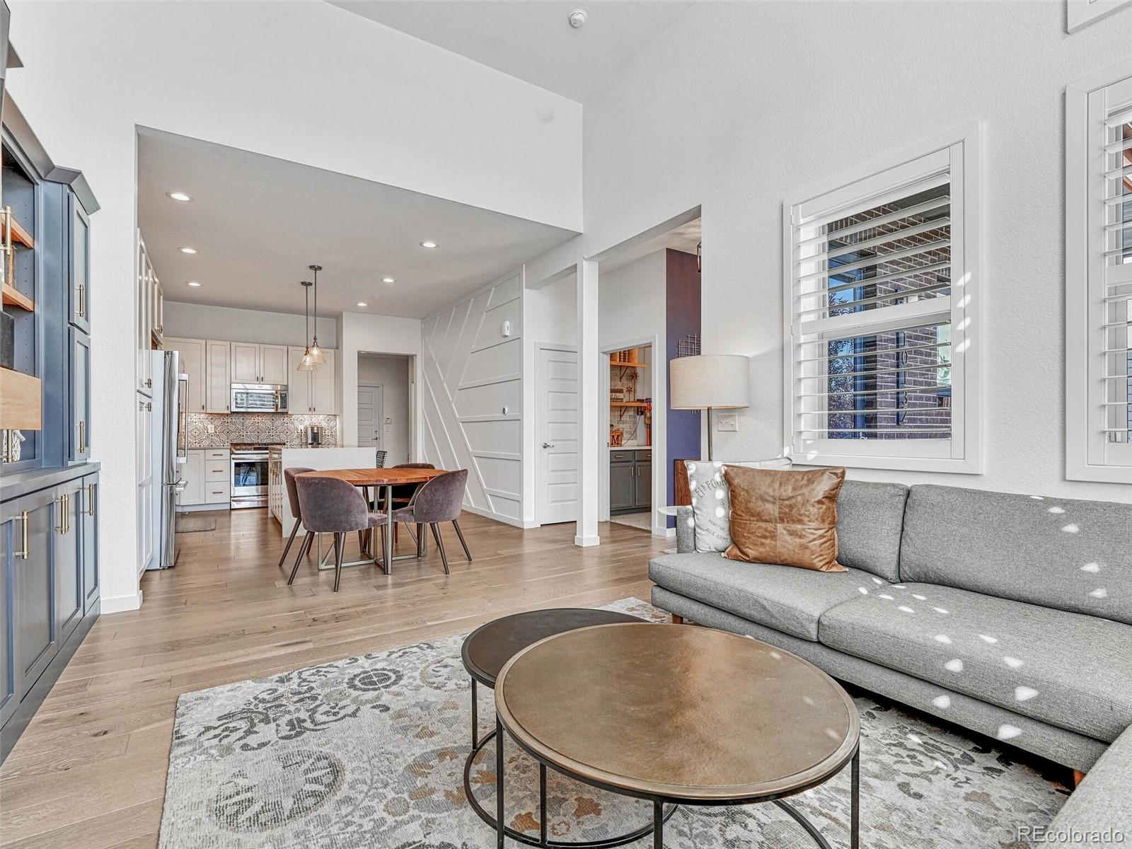 10132 Belvedere Loop Lone Tree, CO 80124 - Photo 5 of 37 a living room with furniture and a dining table