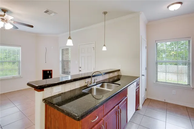 a kitchen that has a sink a stove and a window