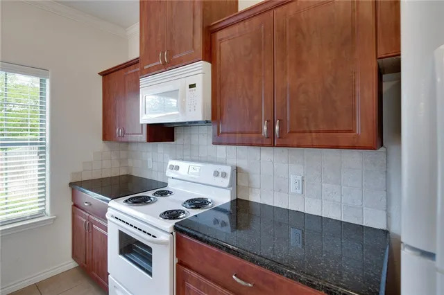 a kitchen with a stove and a microwave