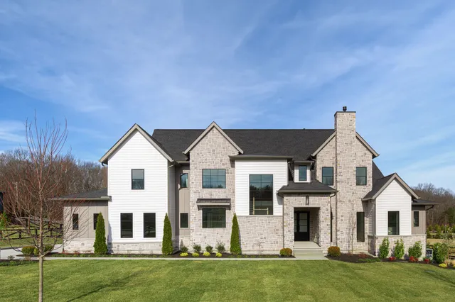 a front view of a house with a garden