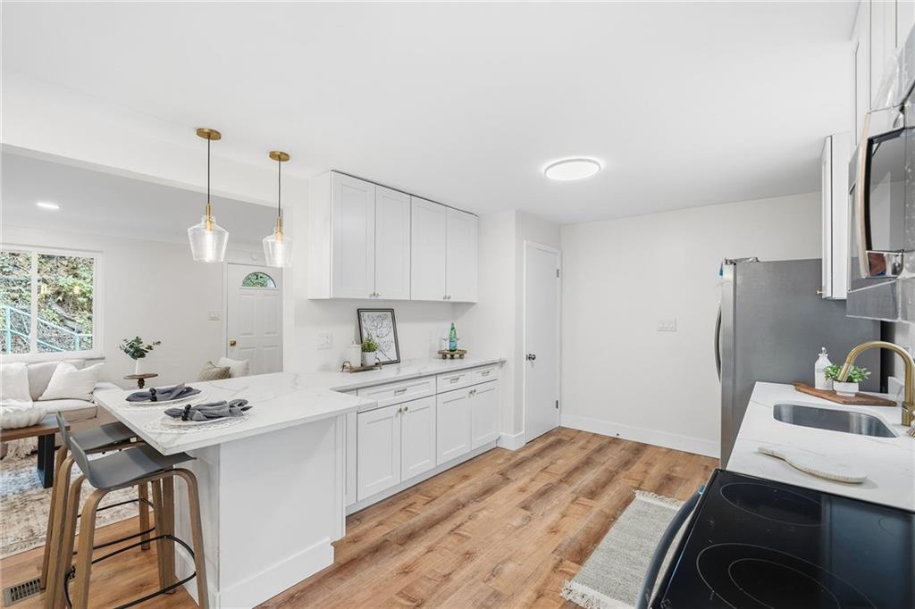 6 Tunstall Street Pittsburgh, PA 15207 - Photo 14 of 49 a kitchen with a sink stove and refrigerator
