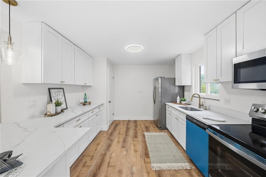 6 Tunstall Street Pittsburgh, PA 15207 - Photo 16 of 49 a large kitchen with a lot of counter space and wooden floor
