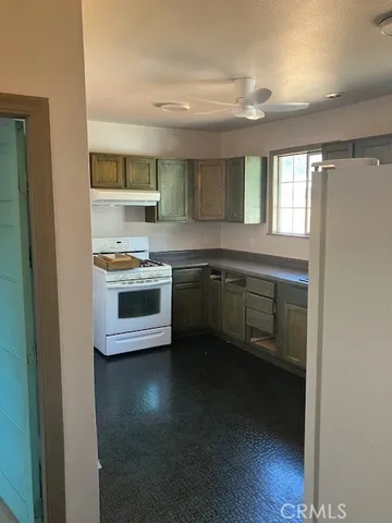 a kitchen with stainless steel appliances a sink stove and cabinets