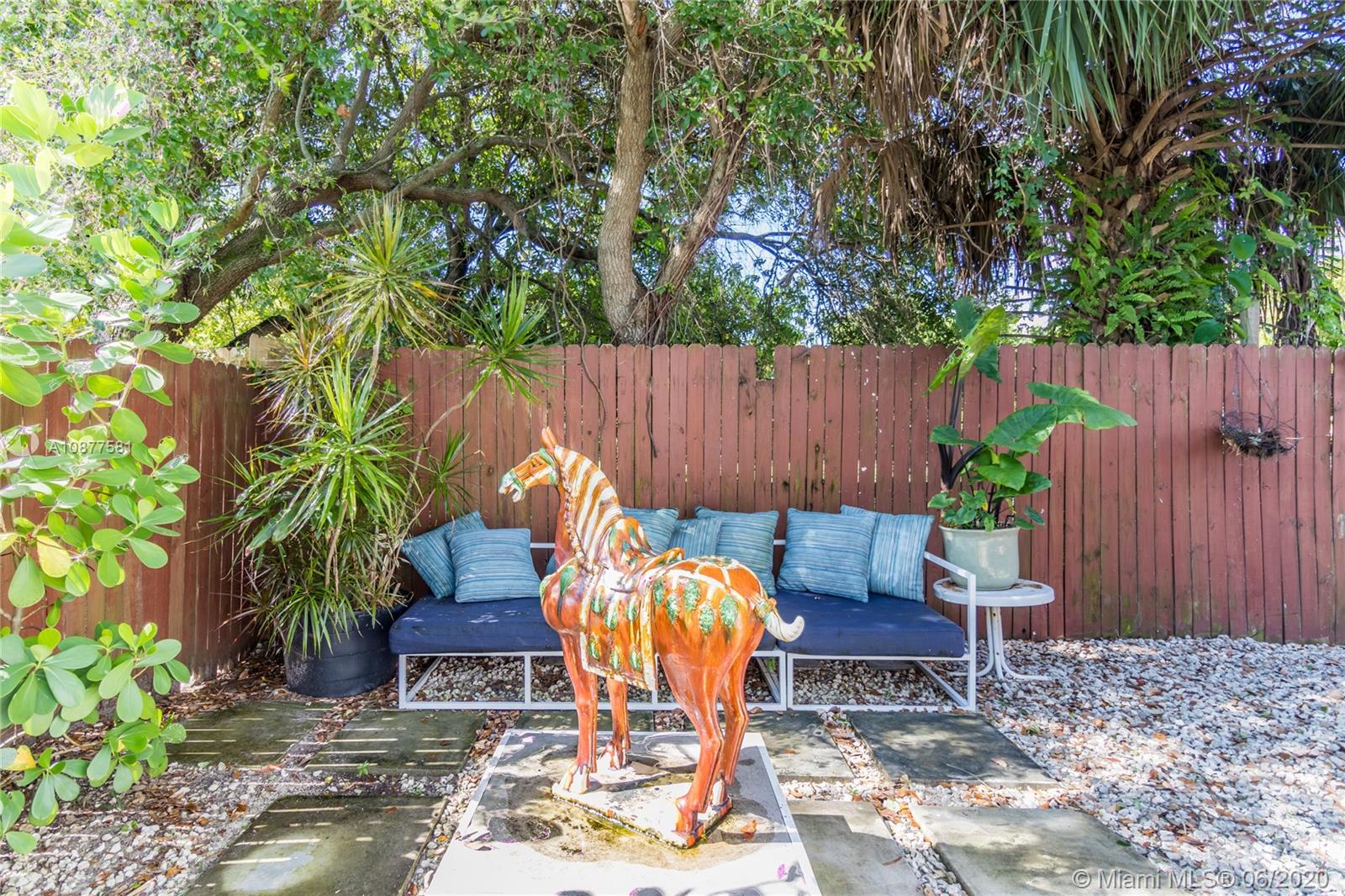 424 Northeast 64th Street, Unit 2 Miami, FL 33138 - Photo 11 of 11 a view of a backyard with a patio and a garden