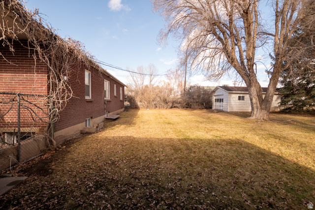 160 North 100 W Street Beaver, UT 84713 - Photo 7 of 36 View of grassy yard featuring an outbuilding
