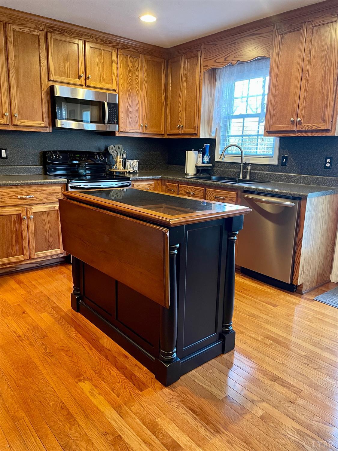 7207 Stage Road Concord, VA 24538 - Photo 11 of 29 a kitchen with stainless steel appliances granite countertop a stove a sink and a microwave
