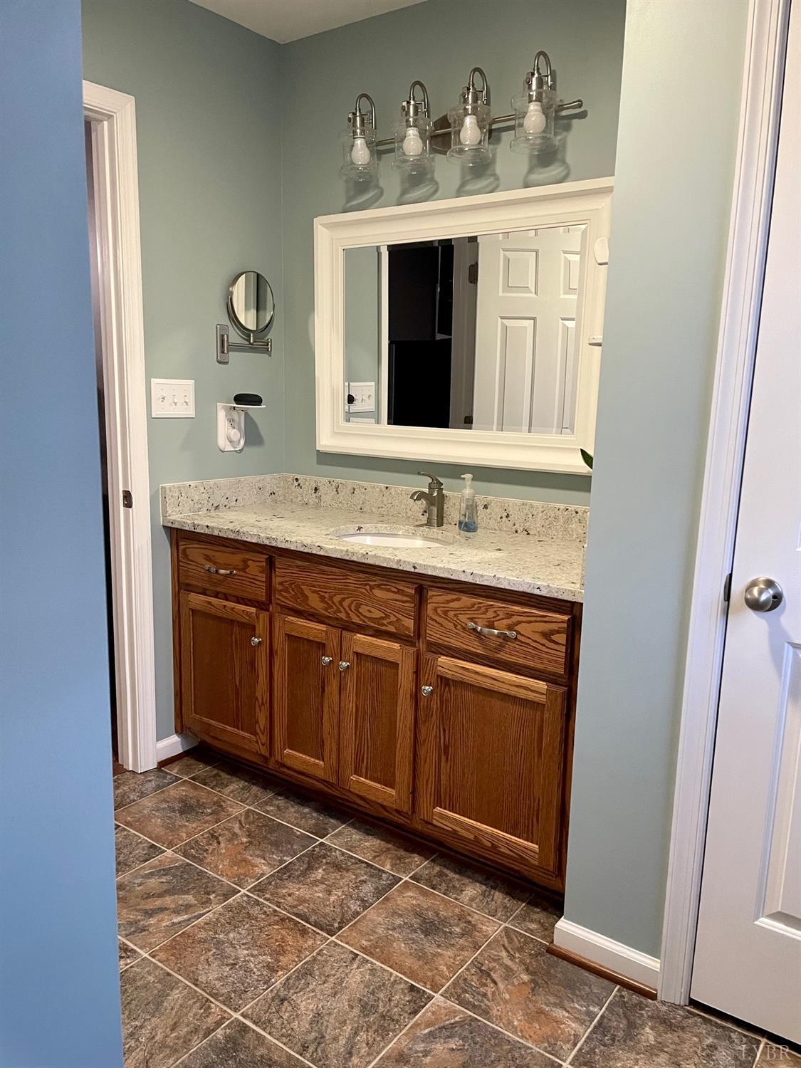 7207 Stage Road Concord, VA 24538 - Photo 19 of 29 a bathroom with a granite countertop sink and a mirror