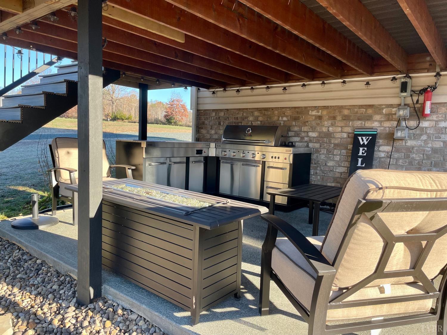 7207 Stage Road Concord, VA 24538 - Photo 27 of 29 a view of a patio with table and chairs a barbeque