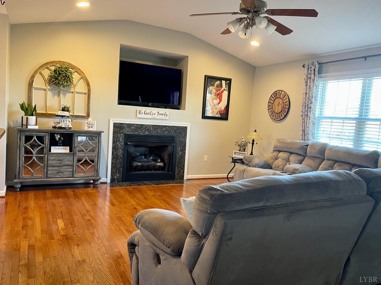 7207 Stage Road Concord, VA 24538 - Photo 8 of 29 a living room with furniture a fireplace and a flat screen tv