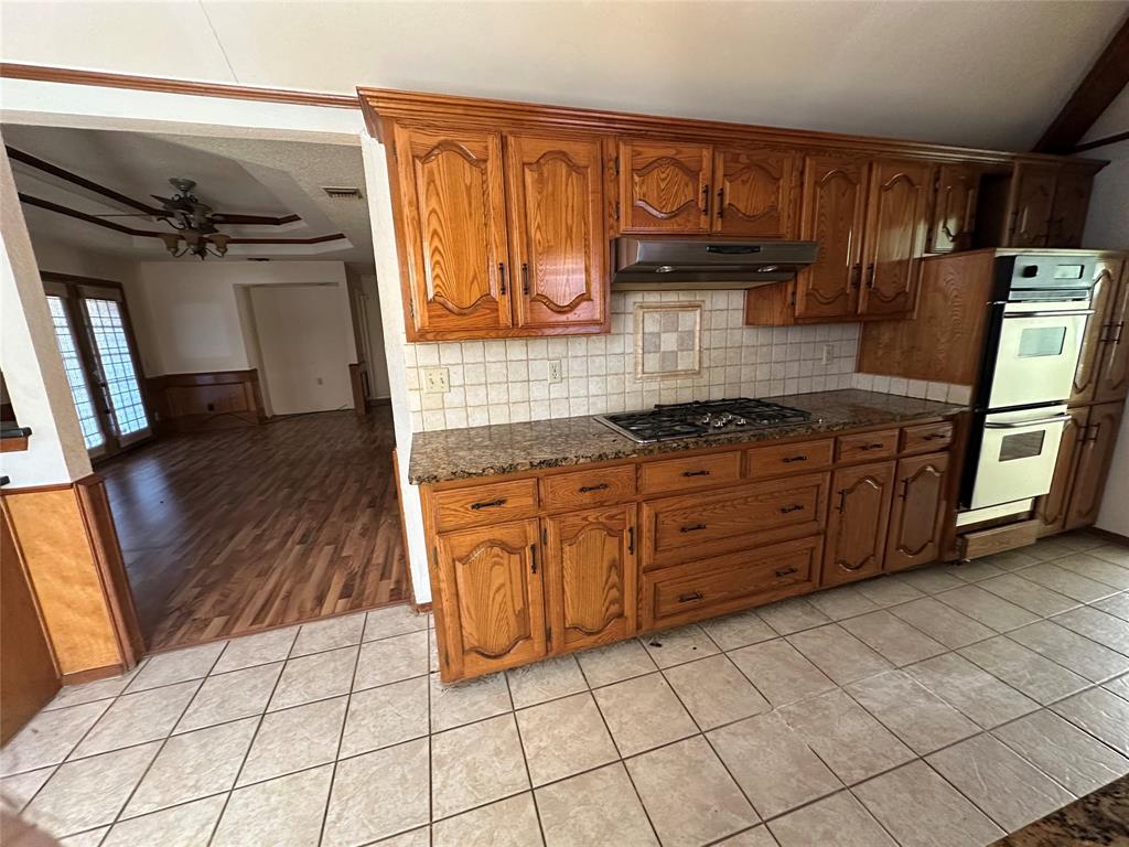 3713 Andrea Lane Rowlett, TX 75088 - Photo 3 of 18 a kitchen with stainless steel appliances granite countertop a stove a sink and a refrigerator